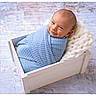 baby, newborn, blue_blanket, wooden_crate, knitted_blanket, smile, face, head, infant, wrapped, cute, portrait, indoors, soft_texture, cozy, child, small, resting, happy, baby_photography
