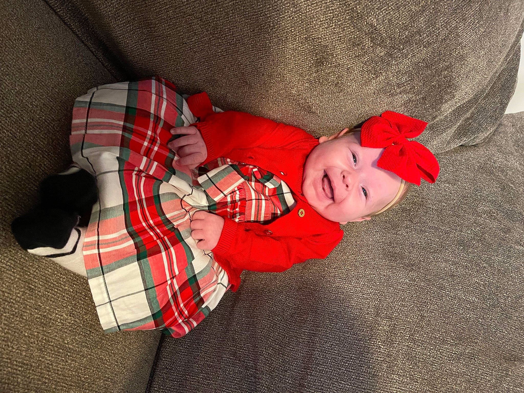 Willow is registered to the contest to win money with this photo: baby, baby_toddler_clothing, carmine, child, comfort, costume, flooring, hat, headwear, linens, pattern, person, plaid, plant, room, sleeve, smile, tartan, textile, toddler