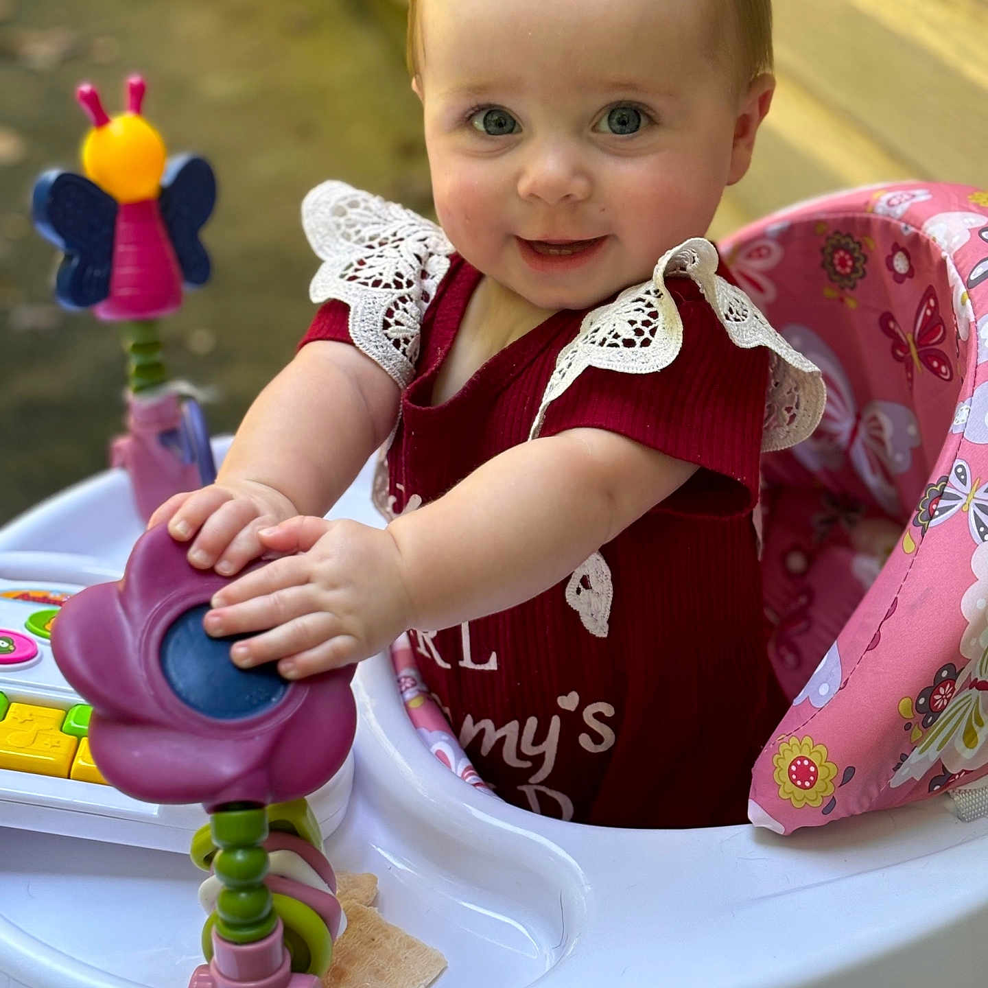 Sadie is registered to the contest to win money with this photo: baby, bodypart, chair, clothing, cutlery, dress, face, furniture, happy, head, outdoorplayarea, outdoors, person, photography, playarea, portrait, sitting, smile, spoon, toy