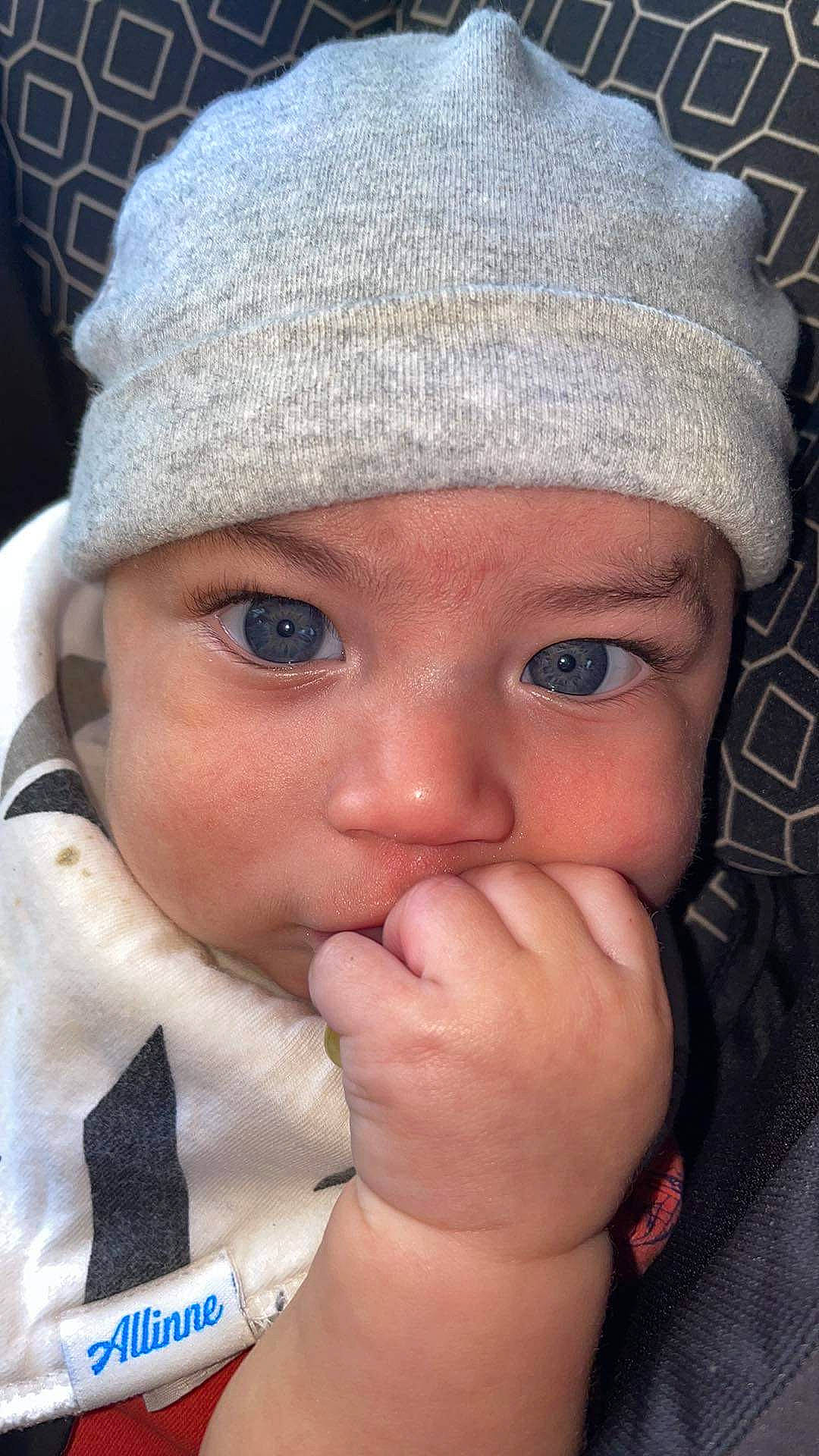 David is registered to the contest to win money with this photo: baby, blue, cap, cheek, chin, eye, eyebrow, eyelash, face, gesture, happy, head, headwear, knit_cap, lip, nose, organ, outerwear, person, skin