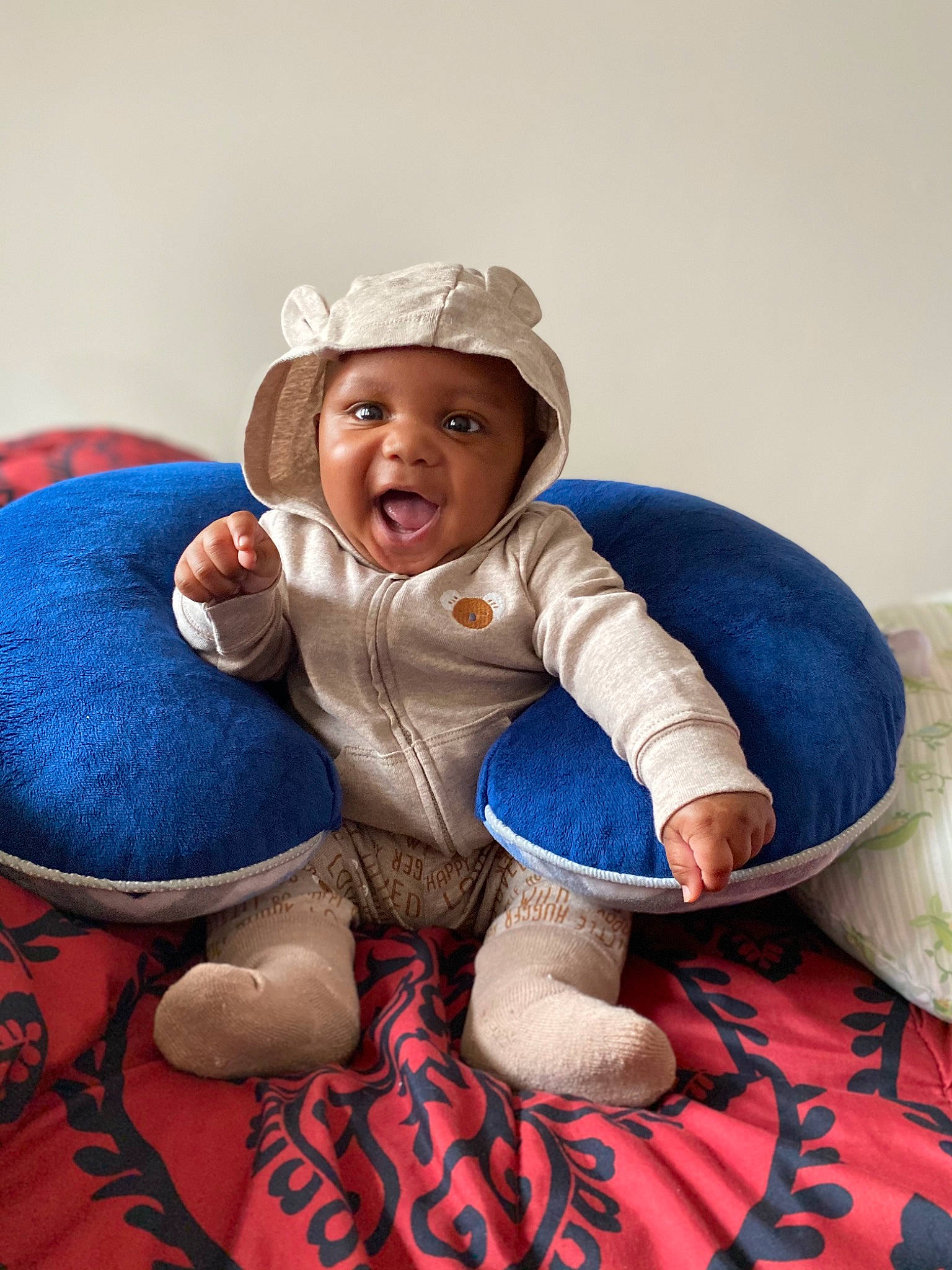 Rasheen is registered to the contest to win money with this photo: baby, baby_toddler_clothing, cap, child, comfort, face, flooring, foot, fun, happy, headgear, headwear, human_leg, leg, linens, person, sitting, sleeve, smile, sock