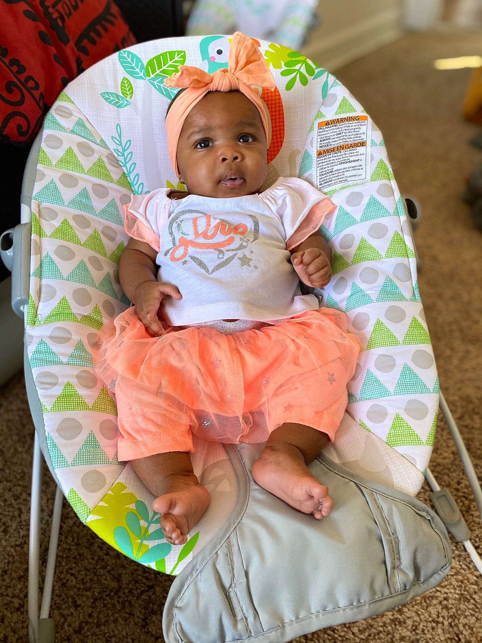 Rhea joined the competition — help win amazing prizes! baby, baby_products, baby_toddler_clothing, chair, child, comfort, dress, event, fun, lap, leisure, orange, pattern, person, pink, product, skin, sleeve, t_shirt, textile