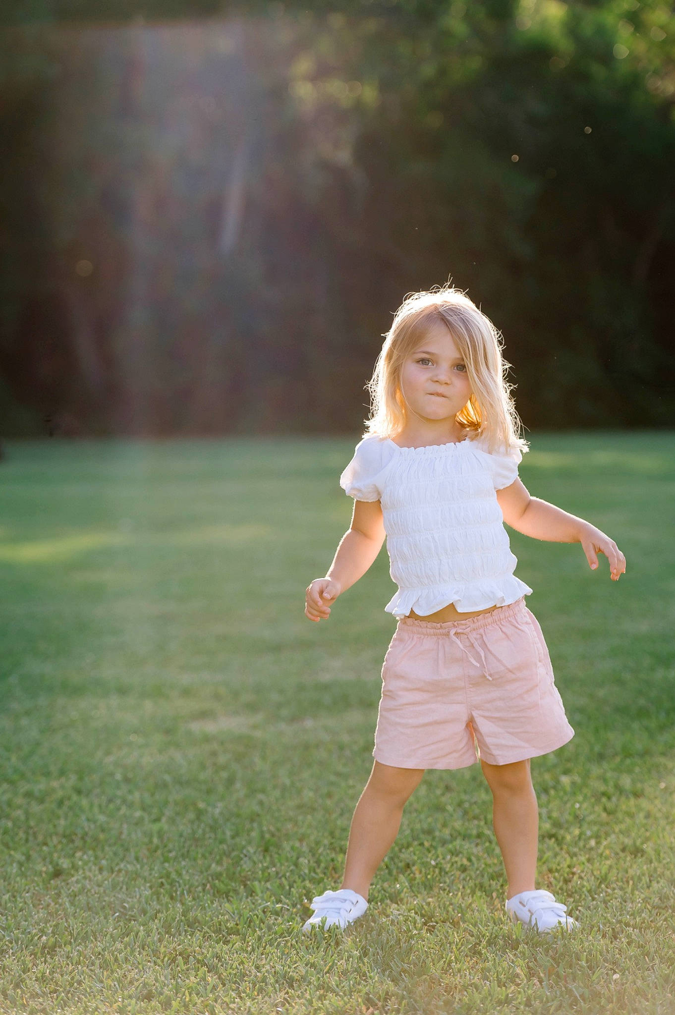 Charlee is registered to the contest to win money with this photo: blond, child, flash_photography, fun, gesture, grass, grassland, happy, human_leg, lawn, leg, leisure, meadow, people_in_nature, person, plant, recreation, toddler, tree, waist