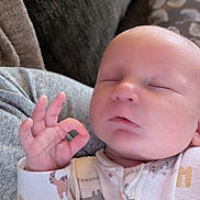 Wyatt joined the competition — help win amazing prizes! baby, sleeping, hand_gesture, onesie, cozy, couch, infant, peaceful, cute, child, soft, home, portrait, closed_eyes, small_hand, relaxed, young, indoors, fabric, comfort