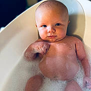 Dougie is registered to the contest to win money with this photo: baby, bathtub, bubbles, foam, child, skin, water, bath, infant, cute, face, head, expression, relaxation, young, person, indoors, clean, bathroom, tub