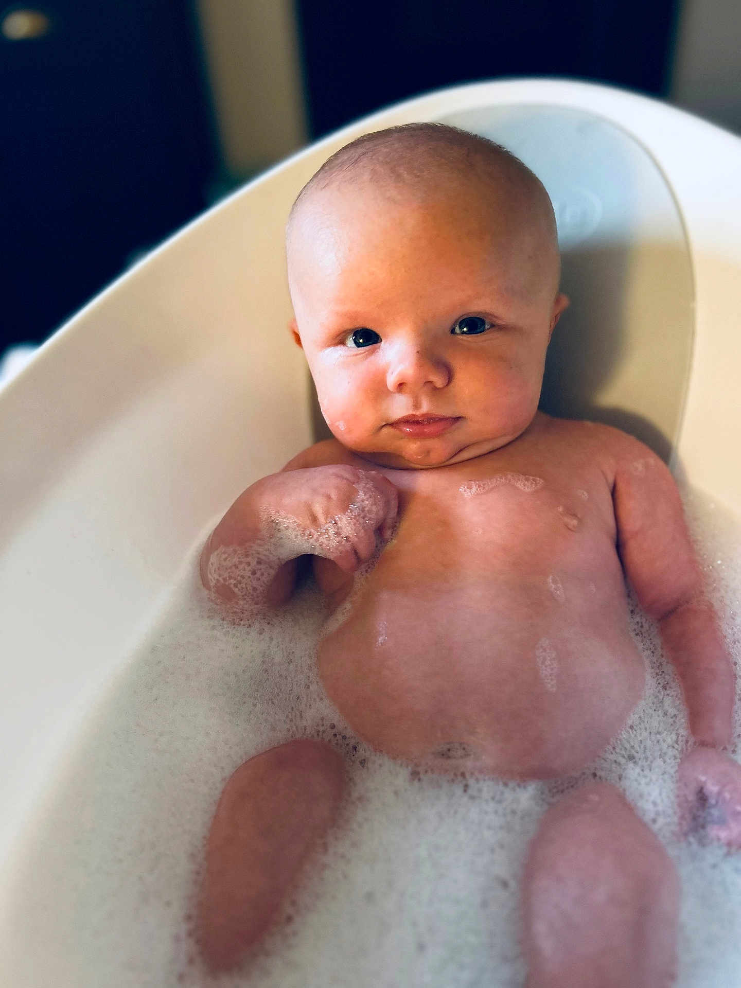 Dougie is registered to the contest to win money with this photo: baby, bathtub, bubbles, foam, child, skin, water, bath, infant, cute, face, head, expression, relaxation, young, person, indoors, clean, bathroom, tub