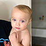 Alexander is registered to the contest to win money with this photo: baby, child, blue_eyes, blonde_hair, indoor, person, portrait, skin, hand, curious, holding, adult, close_up, soft_light, expression, cute, infant, toddler, face, human
