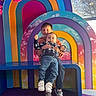 Alexander is registered to the contest to win money with this photo: artistic_background, baby, bench, boy, child, children, clothing, colorful, cute, flowers, happy, indoor, jeans, person, pink_flowers, playful, portrait, rainbow, smiling, sneakers