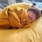 Alexander joined the competition — help win amazing prizes! baby, bear_ears, blanket, brown, child, cozy, cushion, cute, hat, headwear, indoors, infant, newborn, peaceful, portrait, resting, sleeping, soft, wrapped, yellow