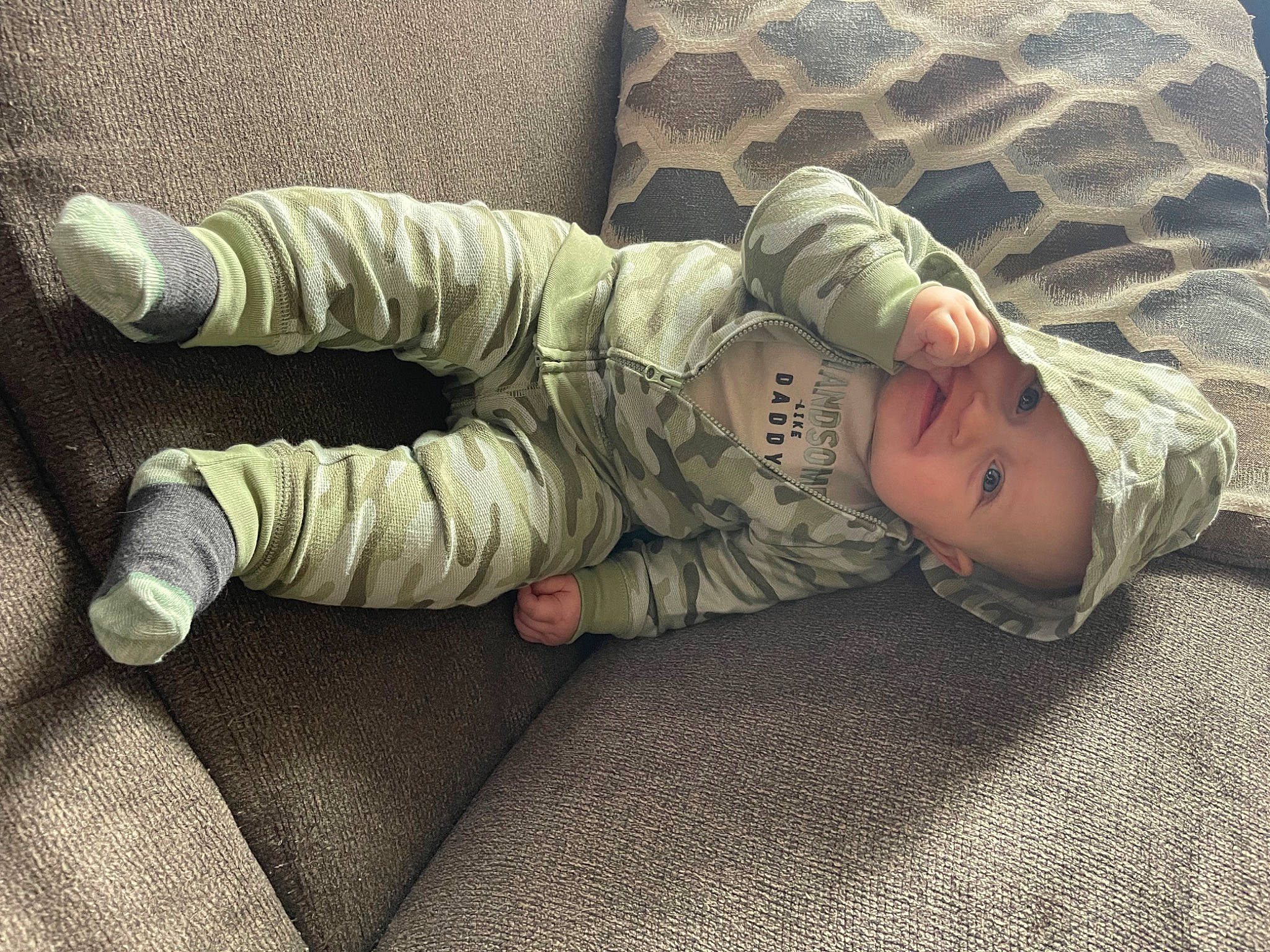 Hendryx joined the competition — help win amazing prizes! baby, baby_toddler_clothing, camouflage, child, comfort, finger, flooring, foot, hand, head, human_body, human_leg, linens, military_camouflage, pattern, person, room, sitting, sleeve, toddler