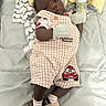 baby, infant, child, portrait, lying_down, bed, blanket, baby_clothes, overalls, checkered_pattern, mittens, socks, shoes, bottle, stuffed_toy, yellow, mint_green, race_car, indoor, sleeping_area