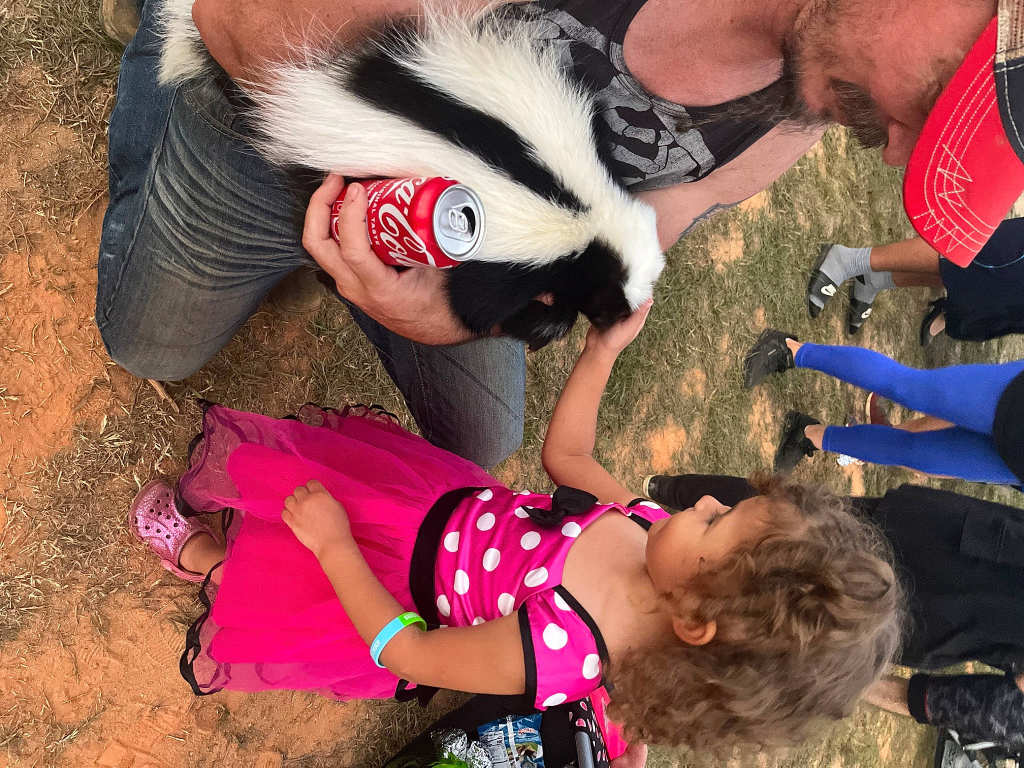 Armani is registered to the contest to win money with this photo: arm, carmine, child, friendship, fun, fur, gesture, grass, hand, happy, human_leg, leisure, people, person, photograph, pink, recreation, red, snapshot, soil