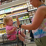 Emma Pauline joined the competition — help win amazing prizes! toddler, child, adult, shopping_cart, grocery_store, aisle, dairy_products, high_five, woman, pacifier, casual_clothing, footwear, socks, blonde_hair, interaction, shopping, retail, supermarket, parent, bonding