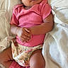 baby, infant, pink_clothing, floral, blanket, sleeping, hands_clasped, leg_warmers, soft_texture, cute, resting, indoors, child, newborn, relaxed, portrait, cozy, skin, person, toddler