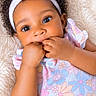 Sequoia is registered to the contest to win money with this photo: adorable, baby, blanket, child, close_up, curly_hair, face, fingers, floral_dress, fluffy_texture, hair_bow, hands, indoors, infant, lying_down, pastel_colors, photography, portrait, smiling, white_headband