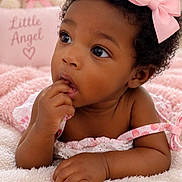 Sequoia is registered to the contest to win money with this photo: baby, child, infant, portrait, close_up, curly_hair, pink_bow, dress, smiling, curious, finger_in_mouth, sitting, blanket, teddy_bear, nursery, pink, cozy, indoors, soft_lighting, adorable