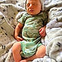 William is registered to the contest to win money with this photo: baby, newborn, sleeping, infant, blanket, onesie, hat, cozy, soft, cute, peaceful, resting, dinosaur_pattern, clothing, child, portrait, indoor, fuzzy, comfort, toddler