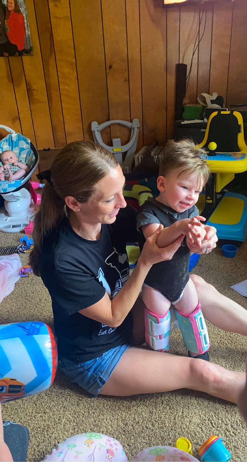 Bennington is registered to the contest to win money with this photo: baby, blue, chair, child, event, fun, grass, happy, human_leg, joy, knee, lap, leisure, person, play, recreation, shorts, sitting, sock, t_shirt