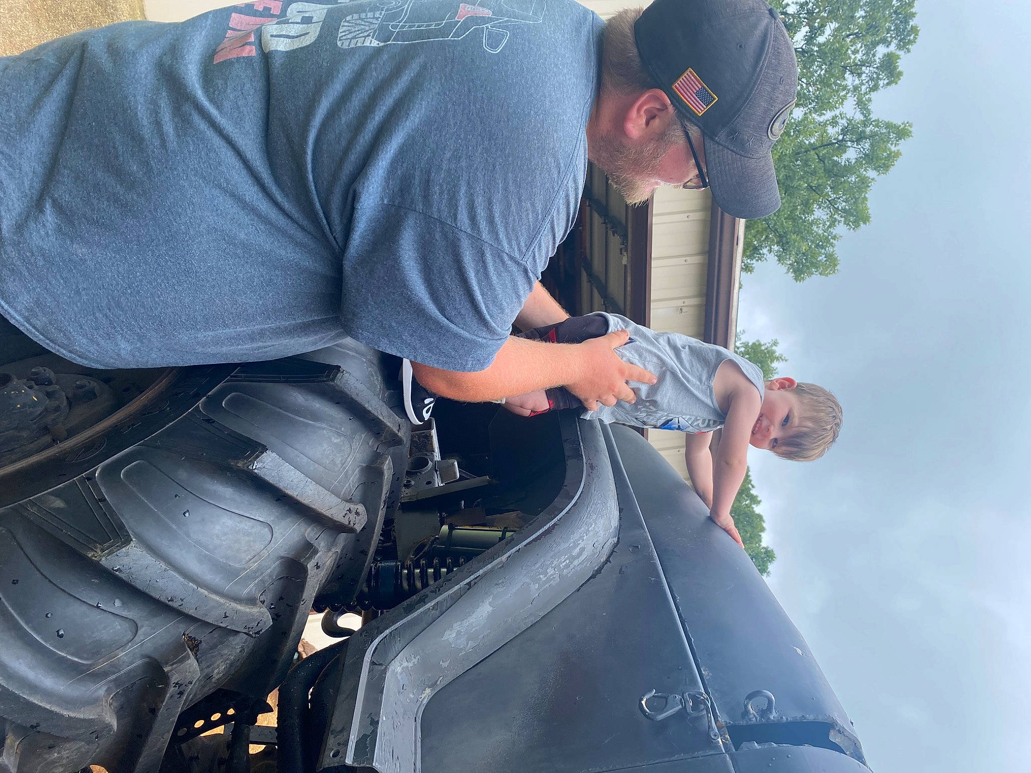 Bennington is registered to the contest to win money with this photo: auto_part, automotive_design, automotive_exterior, automotive_tire, automotive_wheel_system, bumper, cloud, elbow, electric_blue, hat, headwear, joy, luxury_vehicle, motor_vehicle, person, personal_protective_equipment, recreation, sky, sleeve, synthetic_rubber