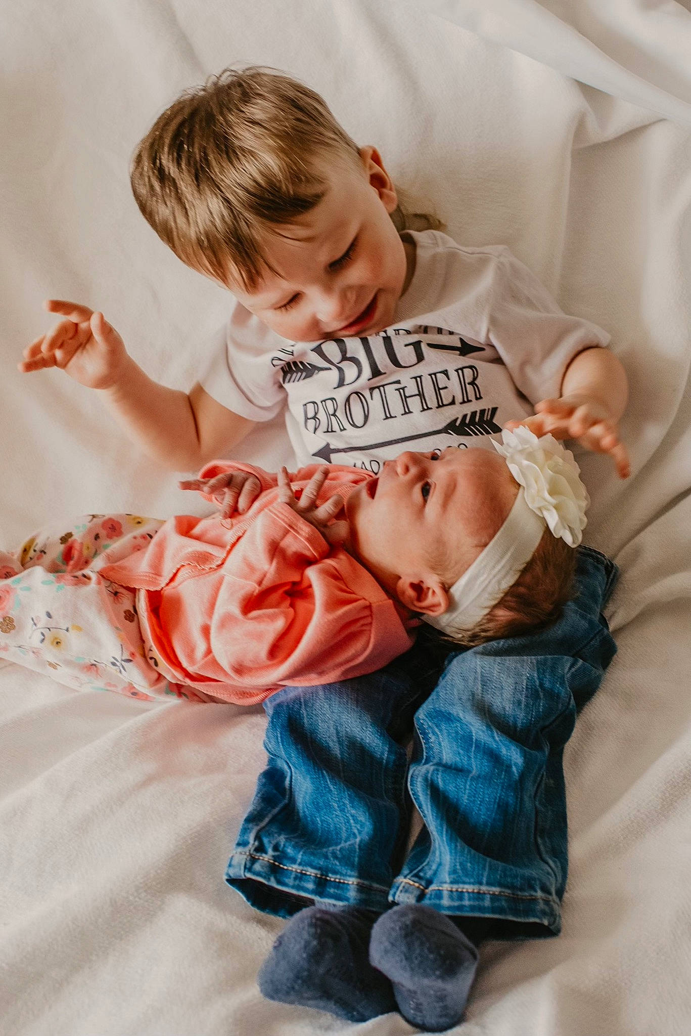 Bennington is registered to the contest to win money with this photo: arm, baby, baby_sleeping, baby_toddler_clothing, child, comfort, finger, fun, gesture, hand, happy, linens, person, pink, play, product, room, sitting, skin, textile