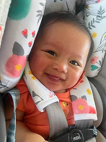 Mirra is registered to the contest to win money with this photo: baby, baby_carriage, baby_in_car_seat, baby_products, baby_toddler_clothing, cheek, child, comfort, eye, eyebrow, facial_expression, finger, happy, iris, joy, linens, person, pink, product, skin