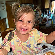 Sienna joined the competition — help win amazing prizes! toddler, child, smiling, breakfast, cereal, milk, kitchen, spoon, pigtails, hair, clothing, table, highchair, wooden_furniture, indoors, happy, face, person, food, meal