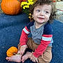 Yz Hezekiah joined the competition — help win amazing prizes! toddler, child, pumpkin, autumn, flowers, outdoor, curly_hair, blue_carpet, smiling, cute, seasonal, fall, nature, sitting, barefoot, happy, young_child, casual_clothing, orange, holiday