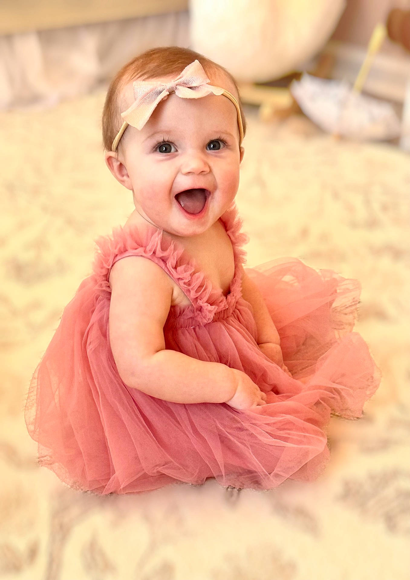 Sophie is registered to the contest to win money with this photo: accessories, baby, babylaughing, bodypart, clothing, costume, dress, face, formalwear, glasses, happy, head, laughing, mouth, person, photography, portrait, sitting, smile, teeth