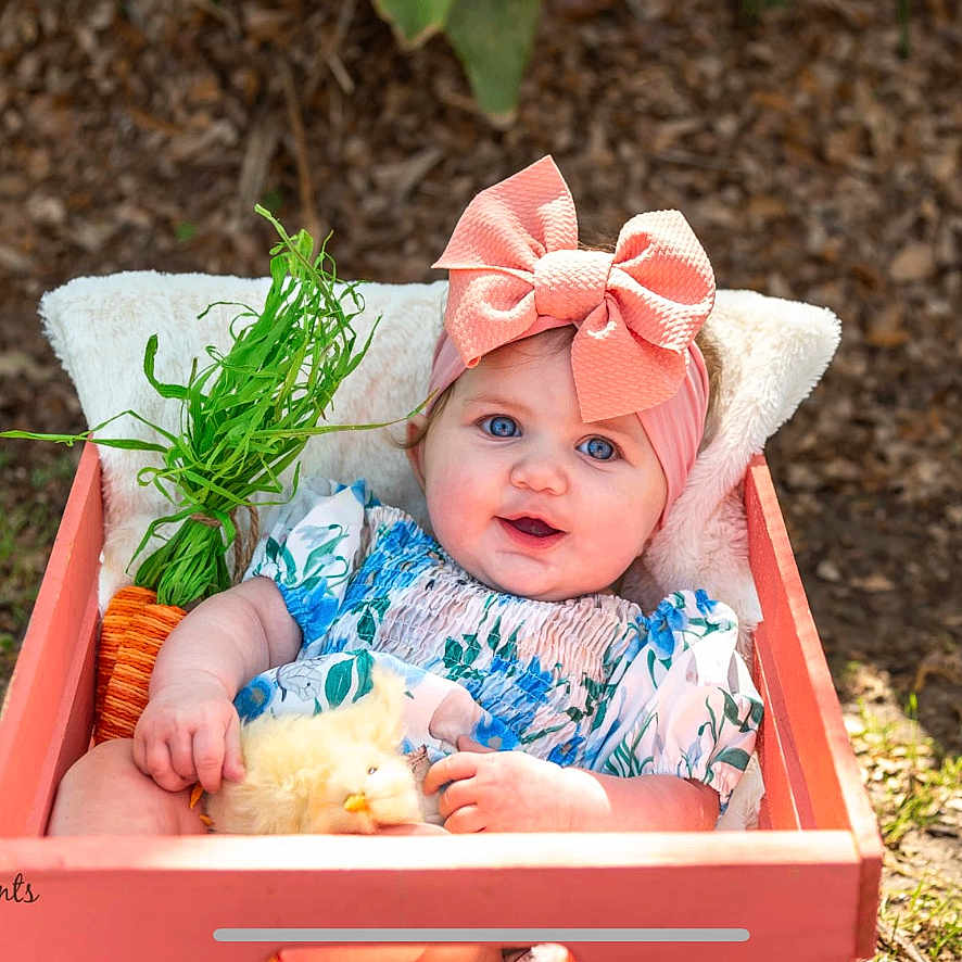 Isabella is registered to the contest to win money with this photo: animal, baby, babylaughing, bonnet, box, cap, cat, clothing, dress, face, happy, hat, head, newborn, person, pet, photography, plant, portrait, pottedplant