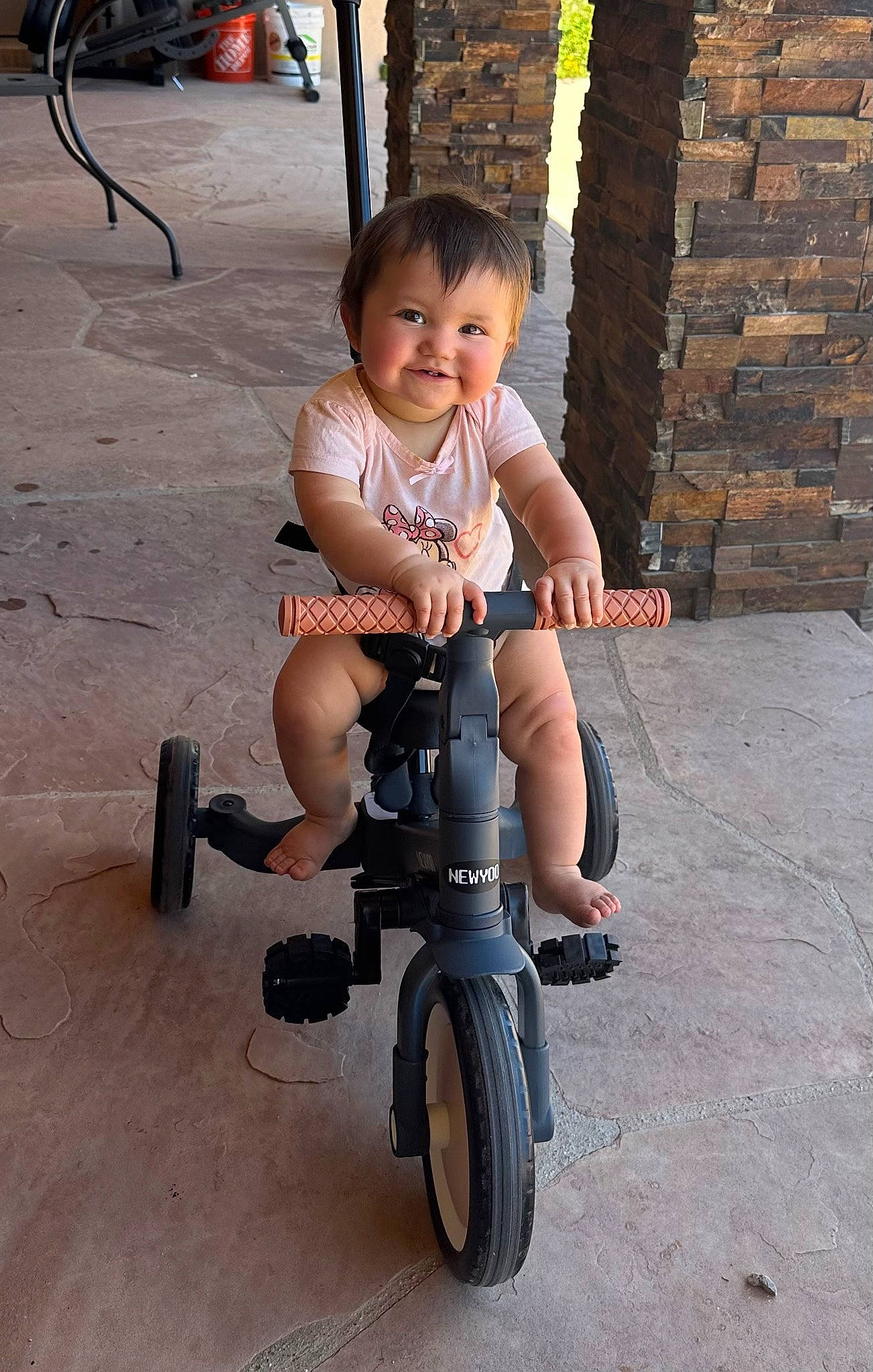 Estrella is registered to the contest to win money with this photo: automotive_tire, automotive_wheel_system, baby_toddler_clothing, bicycle, bicycle_accessory, bicycle_wheel, child, face, fun, joy, person, recreation, riding_toy, rolling, shorts, smile, tire, toddler, toy, tread