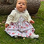 baby, child, girl, blue_eyes, flower_dress, white_cardigan, grass, tree_trunk, outdoor, nature, sitting, cute, curious, portrait, young_child, innocence, soft_lighting, fall, sock, headband