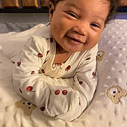 Ivory joined the competition — help win amazing prizes! baby, smiling, curly_hair, blanket, teddy_bear, onesie, cherry_print, crib, wooden, cute, infant, happy, face, portrait, bed, soft, child, sleeping_area, cozy, indoors