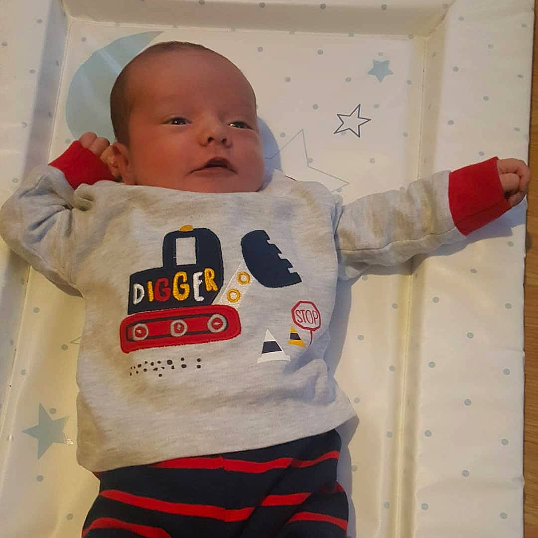 Elijah is registered to the contest to win money with this photo: baby, baby_toddler_clothing, cheek, child, face, finger, head, hoodie, illustration, nose, outerwear, person, play, red, sleeve, t_shirt, textile, toddler, top