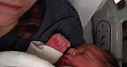 Odin is registered to the contest to win money with this photo: newborn, baby, person, face, sleeping, blanket, hospital_bed, parent, infant, closeup, skin, clothing, bed, rest, tenderness, indoor, family, love, care, quiet