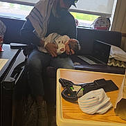 Odin is registered to the contest to win money with this photo: man, baby, newborn, hospital_room, window, curtains, cap, beard, holding, seated, sofa, blanket, medical_equipment, table, remote_control, shoes, bag, indoor, light, tender_moment