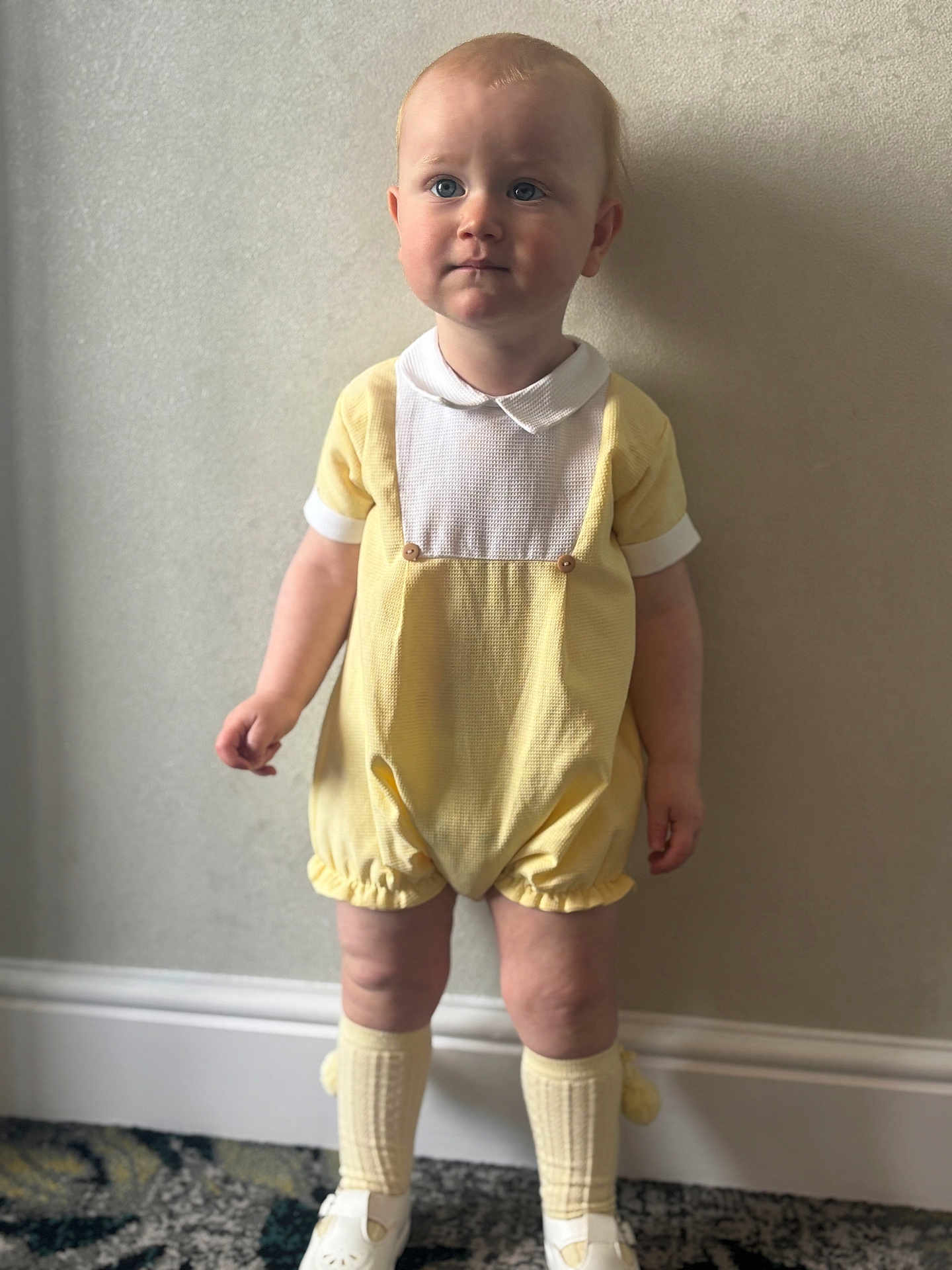 Aarron-Junior joined the competition — help win amazing prizes! baby, carpet, child, clothing, collar, cute, expression, face, feet, indoor, legs, person, portrait, shorts, socks, standing, toddler, wall, white_shoes, yellow_romper