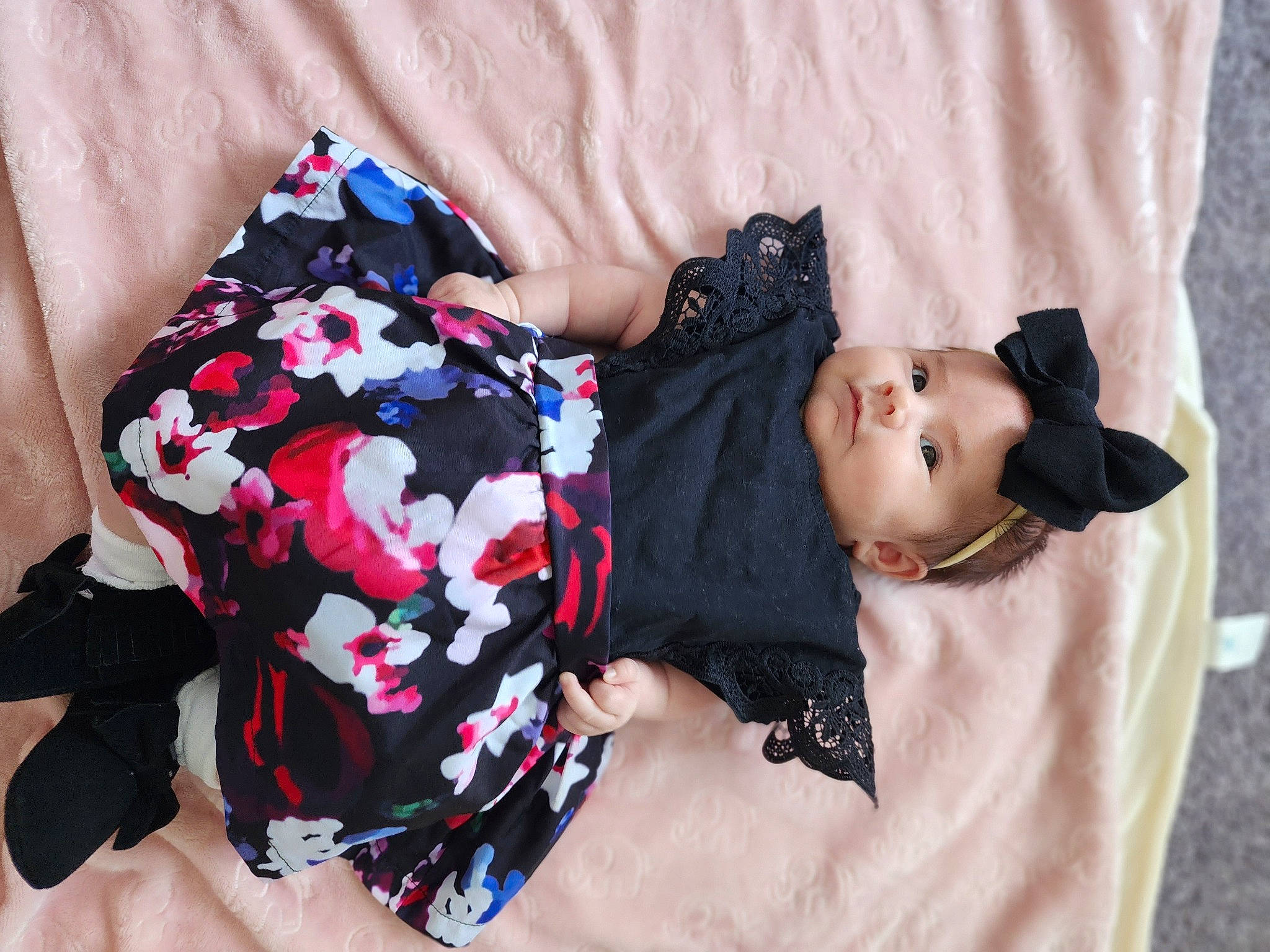 Noemy is registered to the contest to win money with this photo: baby, baby_toddler_clothing, black_hair, child, comfort, dress, fashion_accessory, hat, human_leg, linens, pattern, person, pink, plaid, sitting, skin, sleeve, textile, thigh, toddler