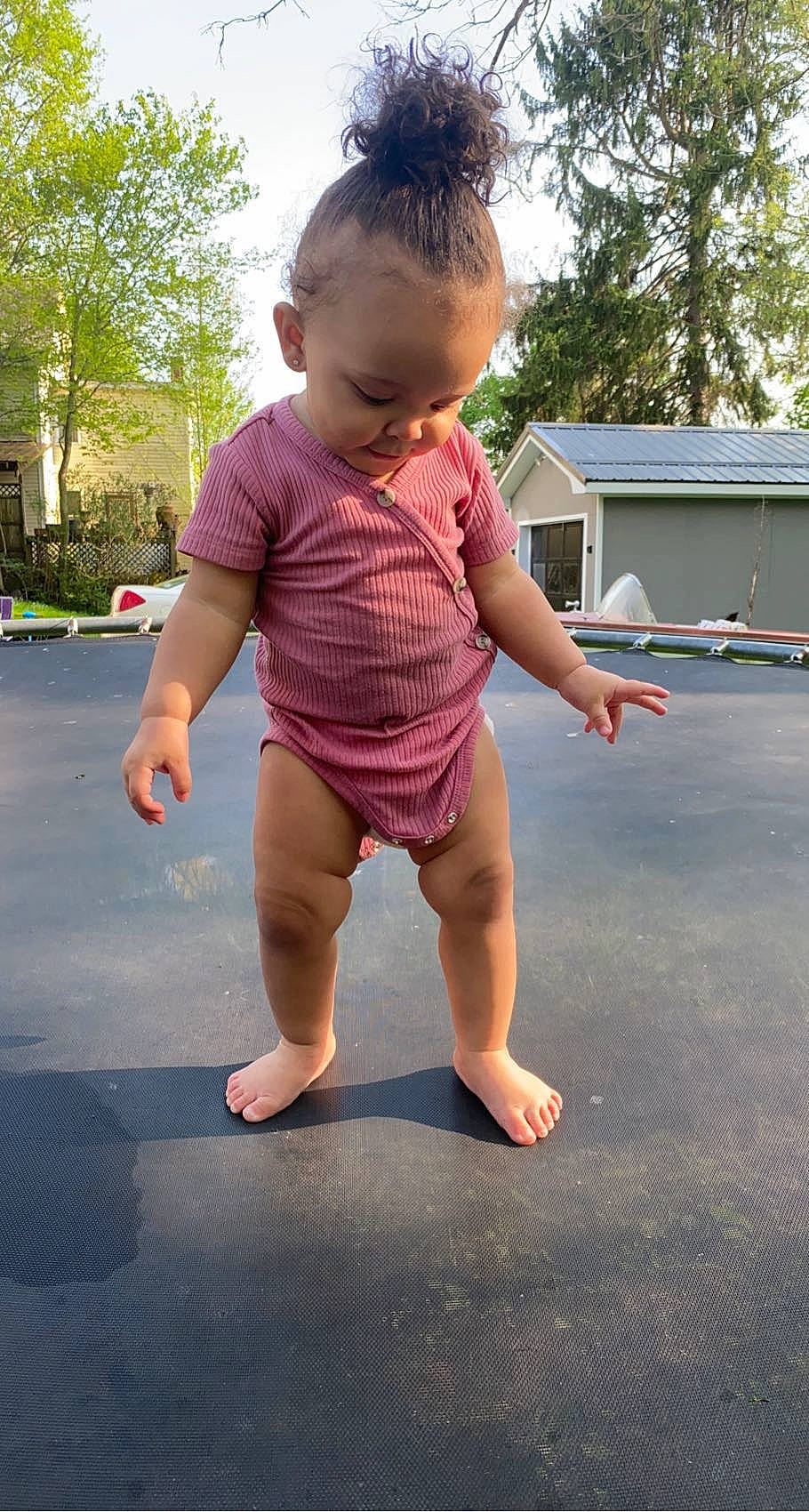 Halo is registered to the contest to win money with this photo: asphalt, baby_toddler_clothing, barefoot, finger, fun, gesture, grass, hand, happy, joint, leg, leisure, person, sky, sleeve, t_shirt, thigh, thumb, toddler, trampolining_equipment_and_supplies