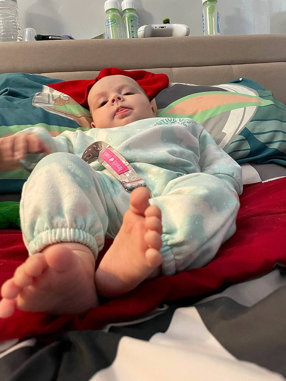 Layla is registered to the contest to win money with this photo: baby, baby_sleeping, barefoot, child, comfort, couch, elbow, finger, foot, human_leg, knee, lap, leg, linens, nail, person, sitting, sock, textile, thigh