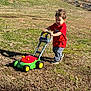 Adelio joined the competition — help win amazing prizes! child, toddler, push_toy, toy_mower, grass, outdoor, red_shirt, casual_clothes, walking, pushing, shoes, sunlight, shadow, lawn, play, young_child, portrait, barn, fence, concentration