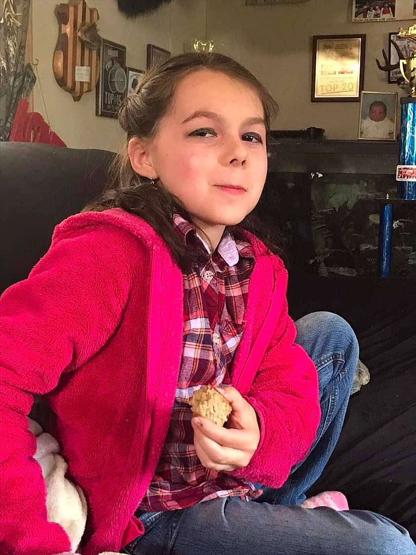 Lindsey is registered to the contest to win money with this photo: child, christmas, collar, comfort, couch, fashion_accessory, flash_photography, fun, fur, happy, iris, lamp, magenta, pattern, person, picture_frame, plaid, sitting, sleeve, television