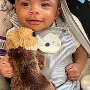 James joined the competition — help win amazing prizes! baby, child, clothing, cute, eyes, fabric, face, hand, happy, infant, overalls, person, plush_toy, portrait, seat, smile, soft_toy, striped_clothing, stroller, stuffed_animal