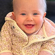 Esmè joined the competition — help win amazing prizes! baby, smiling, blue_eyes, floral_jacket, cozy_clothing, infant, cute, happy, portrait, close_up, child, warm, soft_light, indoor, human, young, face, head, sitting, adorable