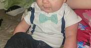 Owen joined the competition — help win amazing prizes! baby, child, infant, portrait, sitting, smiling, bow_tie, suspenders, white_shirt, jeans, sneakers, fashion, indoor, bedroom, bed, blanket, family, closeup, flash_photography, happy