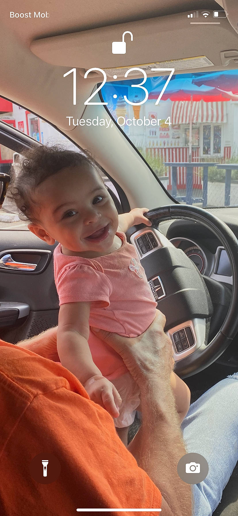 Adriana is registered to the contest to win money with this photo: auto_part, automotive_design, automotive_exterior, automotive_lighting, automotive_tire, car, car_seat, cool, happy, joy, mode_of_transport, motor_vehicle, person, personal_luxury_car, smile, steering_part, steering_wheel, toddler, vehicle, vehicle_door