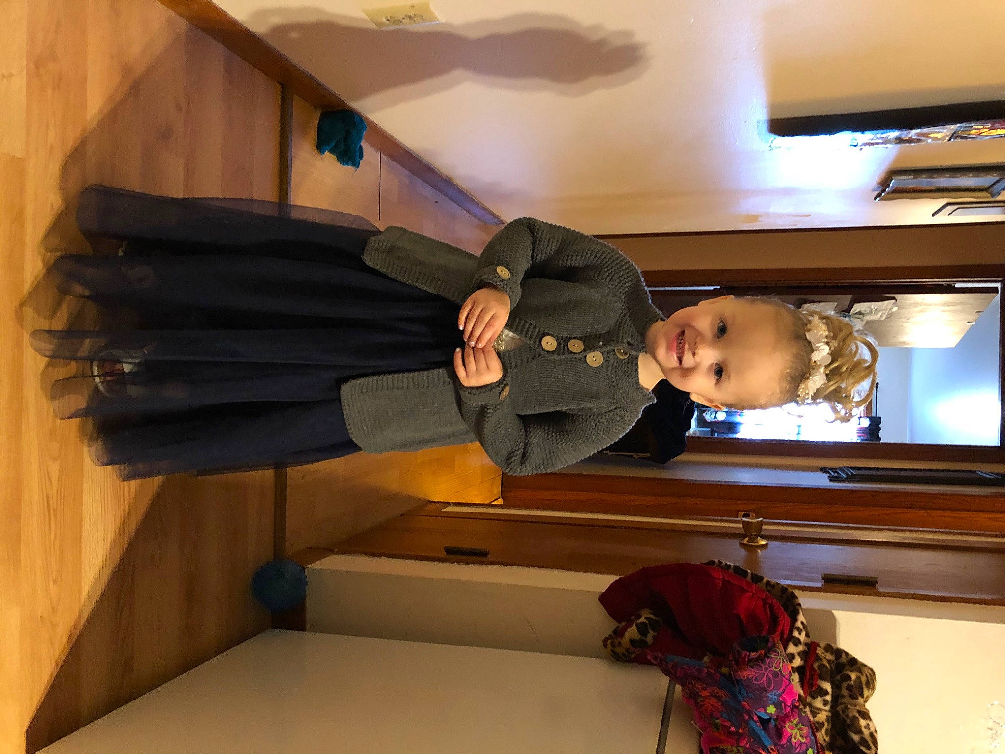 Gwendolyn is registered to the contest to win money with this photo: backpack, bag, baggage, ceiling, comfort, couch, flooring, fun, hardwood, hat, home_appliance, house, interior_design, jacket, joy, luggage_and_bags, person, room, television, television_set