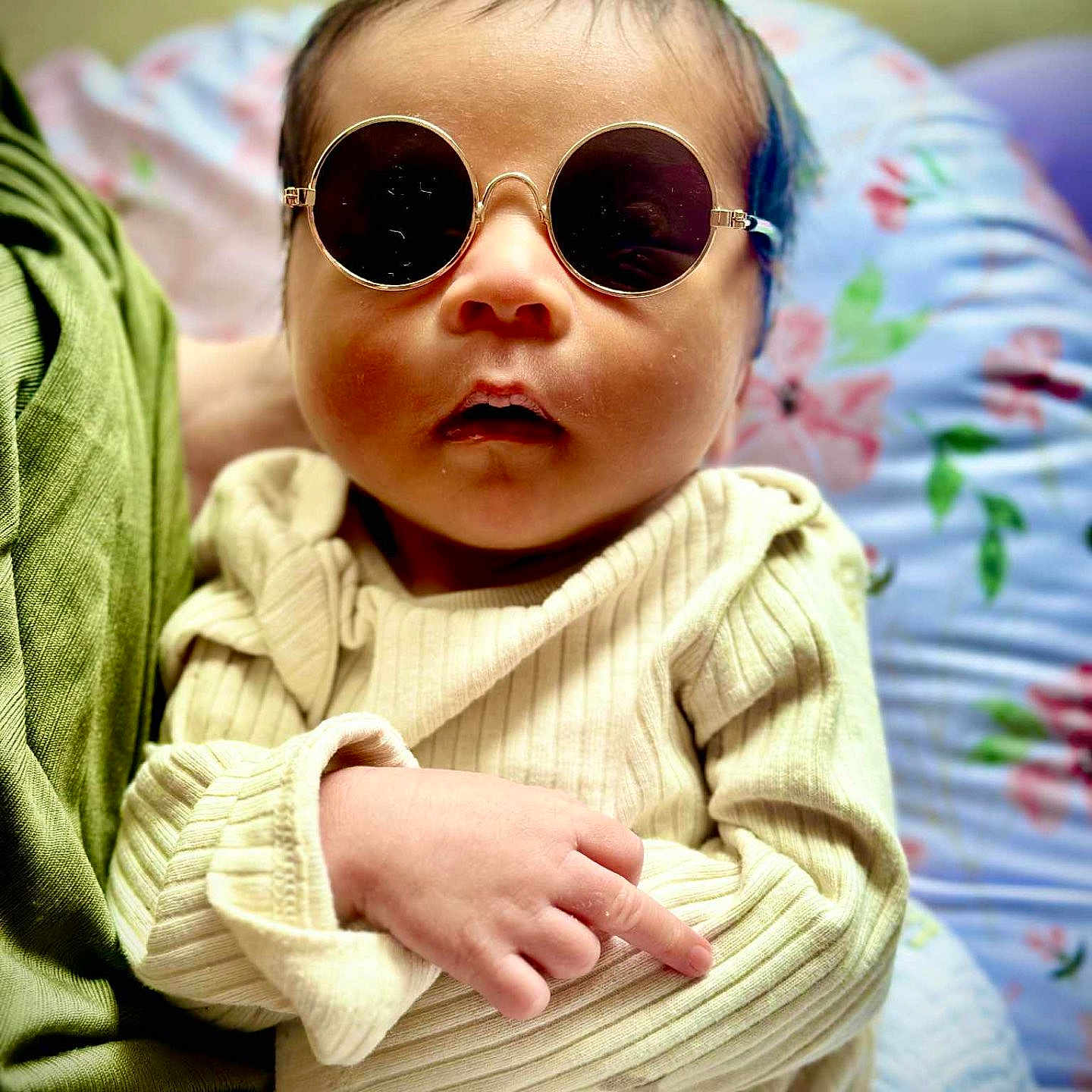 Zillion P Dorji is registered to the contest to win money with this photo: baby, child, clothing, colorful, cozy, cushion, cute, face, fashion, hand, indoor, infant, person, portrait, resting, sitting, sleeve, soft, sunglasses, young