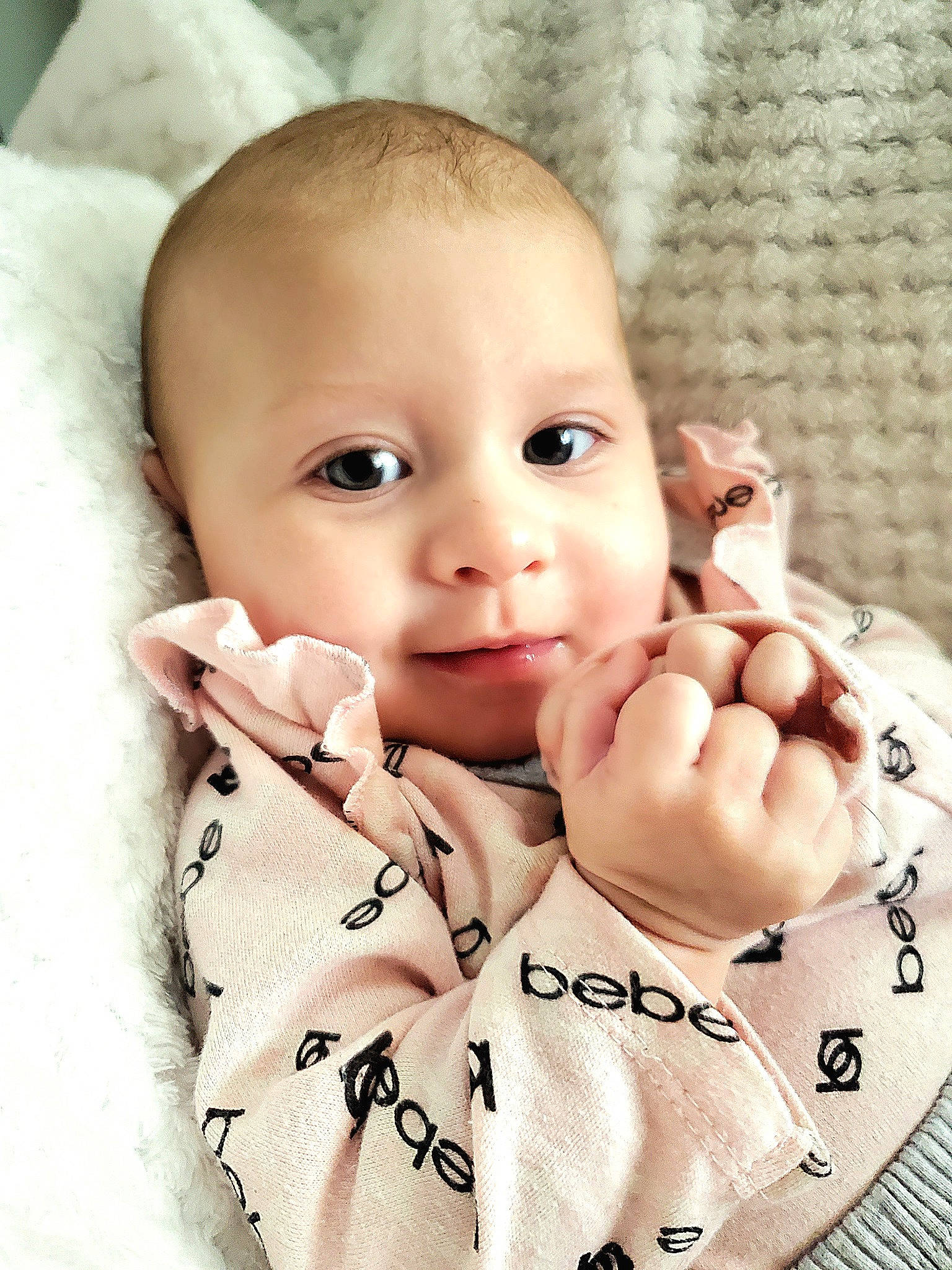 Gwen is registered to the contest to win money with this photo: arm, baby, baby_toddler_clothing, cheek, comfort, eye, eyelash, finger, gesture, hand, head, lip, mouth, nail, nose, person, skin, sleeve, textile, thumb