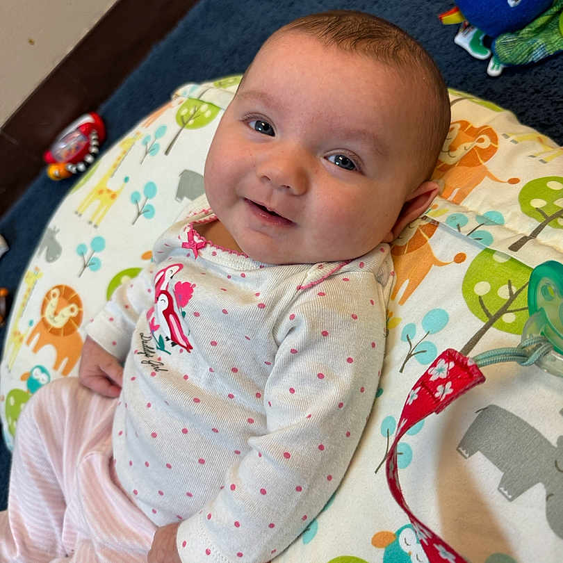 Bailee is registered to the contest to win money with this photo: applique, baby, bed, blanket, bodypart, couch, cushion, face, finger, furniture, hand, head, homedecor, newborn, pattern, person, photography, portrait, quilt, toy