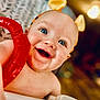 Anakyn joined the competition — help win amazing prizes! baby, child, smiling, blue_eyes, headband, toy, red, yellow, happy, close_up, indoor, skin, face, expression, cute, infant, cheerful, playful, person, portrait